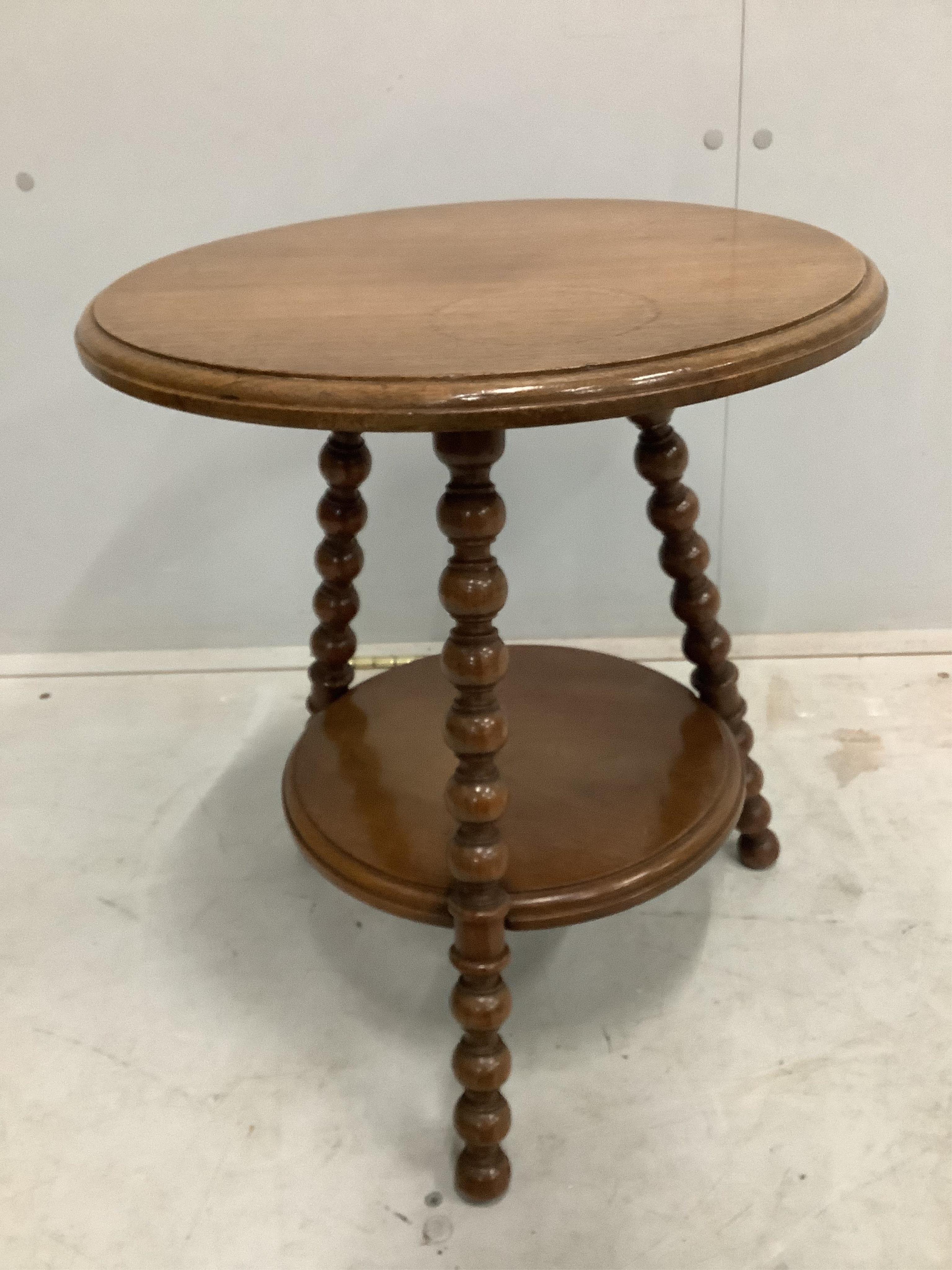 An Edwardian oval mahogany inlaid tea tray, width 55cm, and a late Victorian bobbin turned circular two tier occasional table. Condition - fair